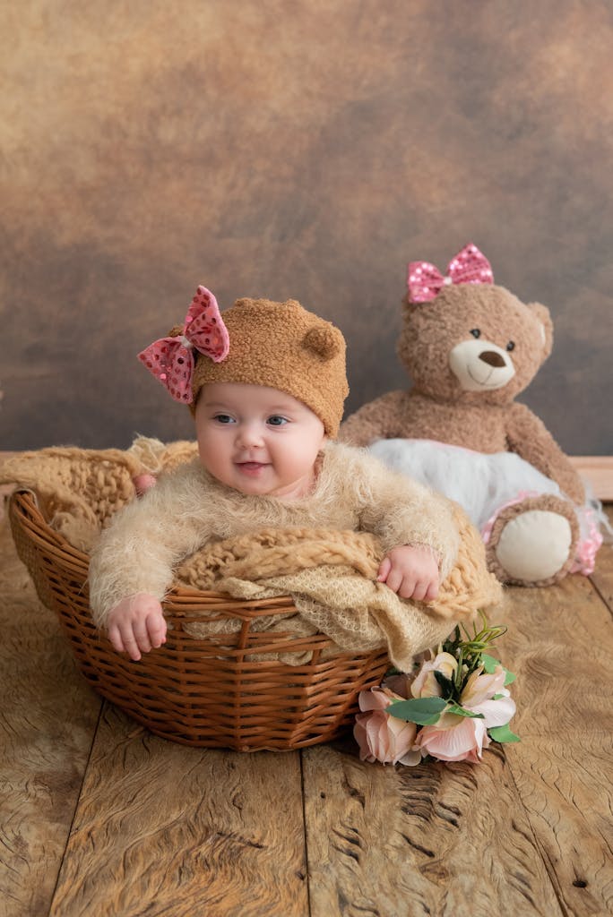 A baby girl in a basket with two teddy bears