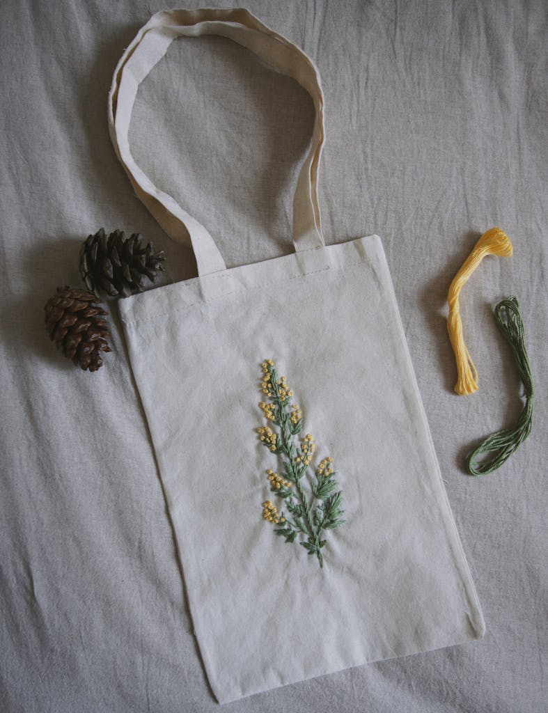A Cotton Tote Bag with Flowers and Leaves Design