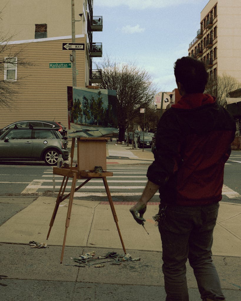 A man painting on a street corner