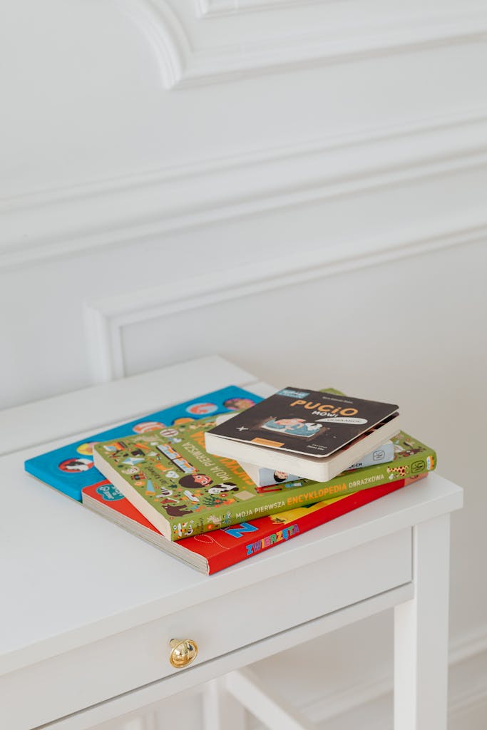 A Stack of Baby Books on a White Table