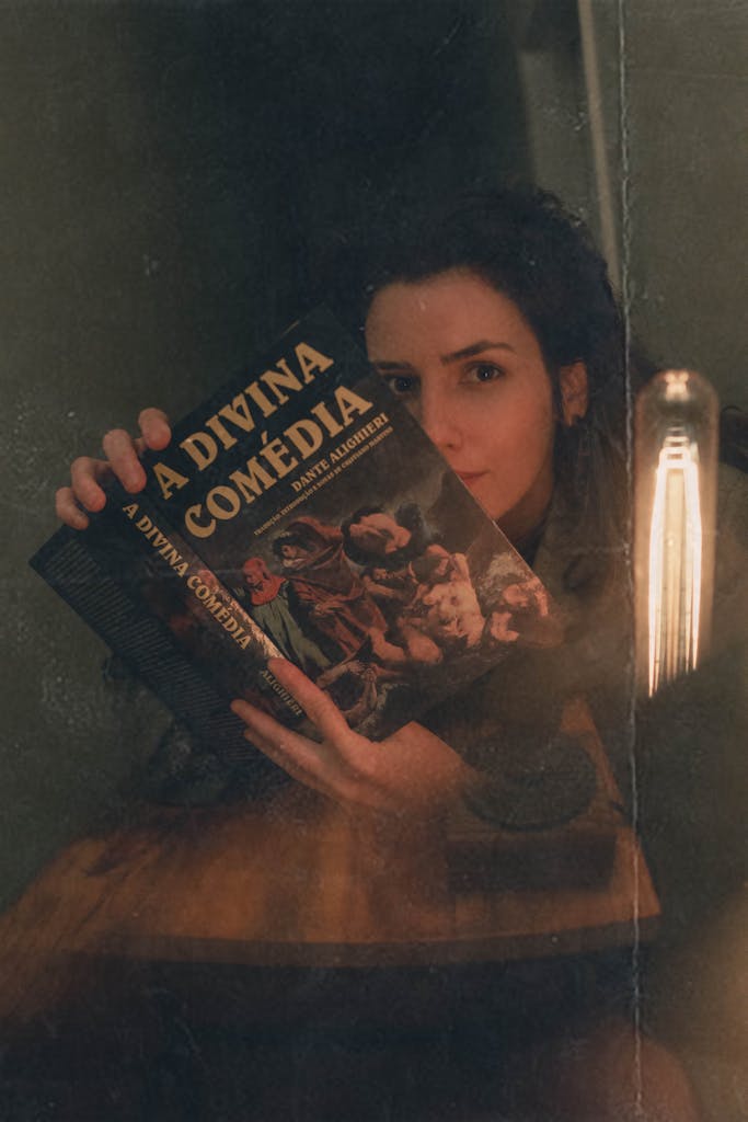 An Old Photo of a Woman Holding the Divine Comedy Book