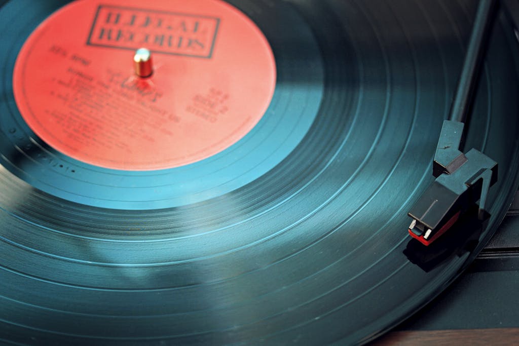 Blue Vinyl Record Playing on Turntable