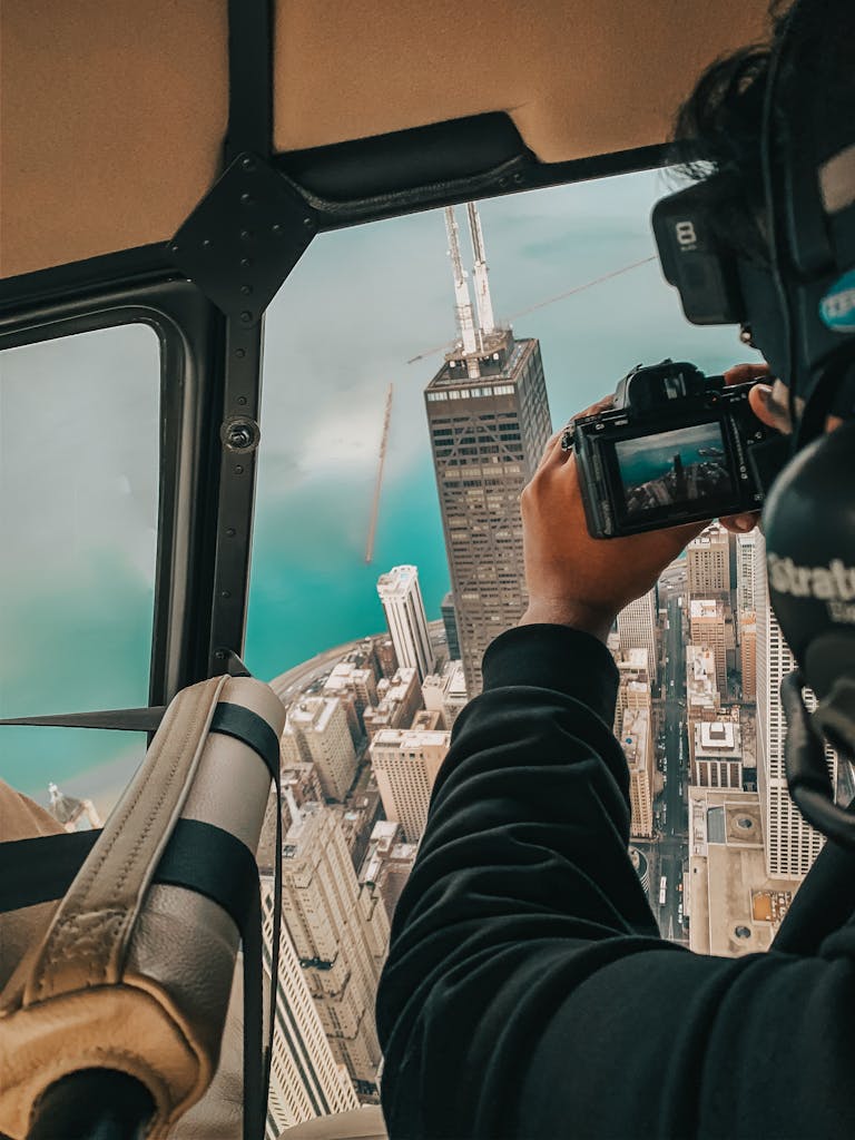 Man Photographing the Panorama of New York City From a Helicopter