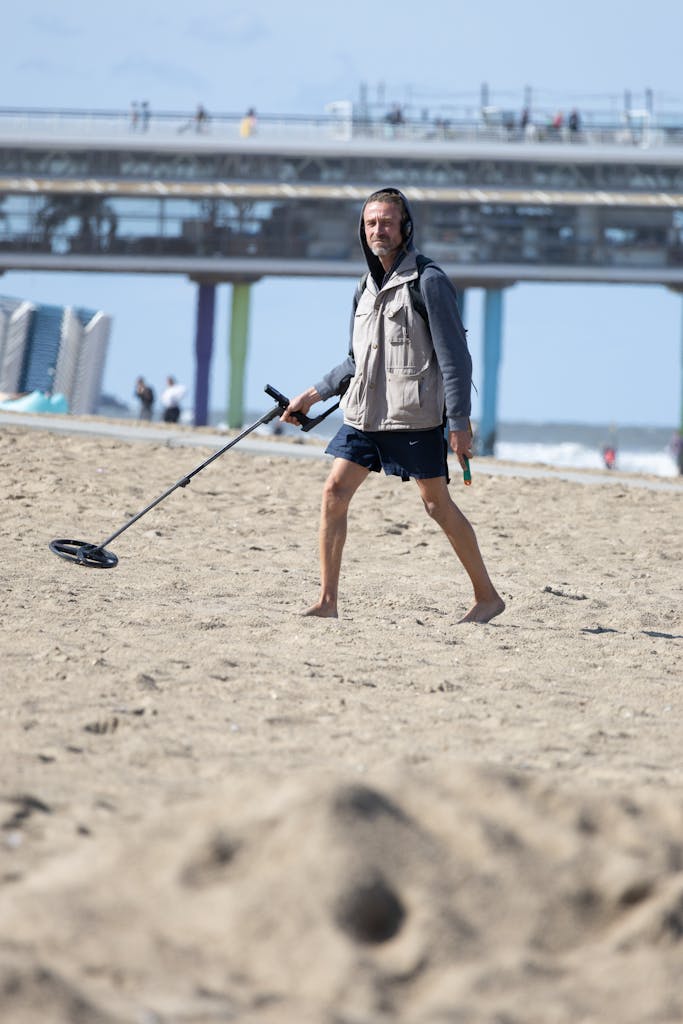 Man with Metal Detector on Beach