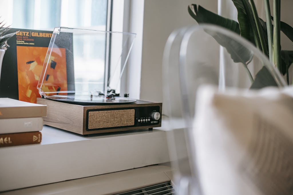 Retro record player on windowsill at home