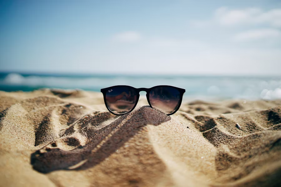 a pair of sunglasses on the sand